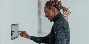 A man making an adjustment to a smart thermostat